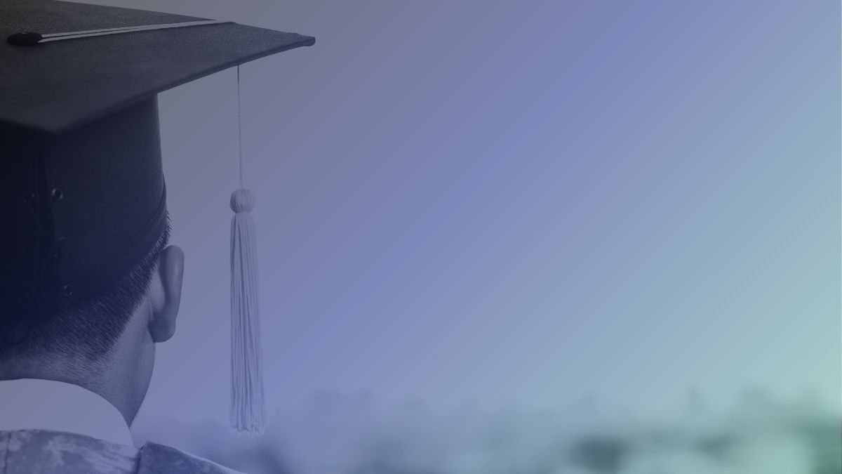 A man with his back to the viewer, wearing graduation regalia